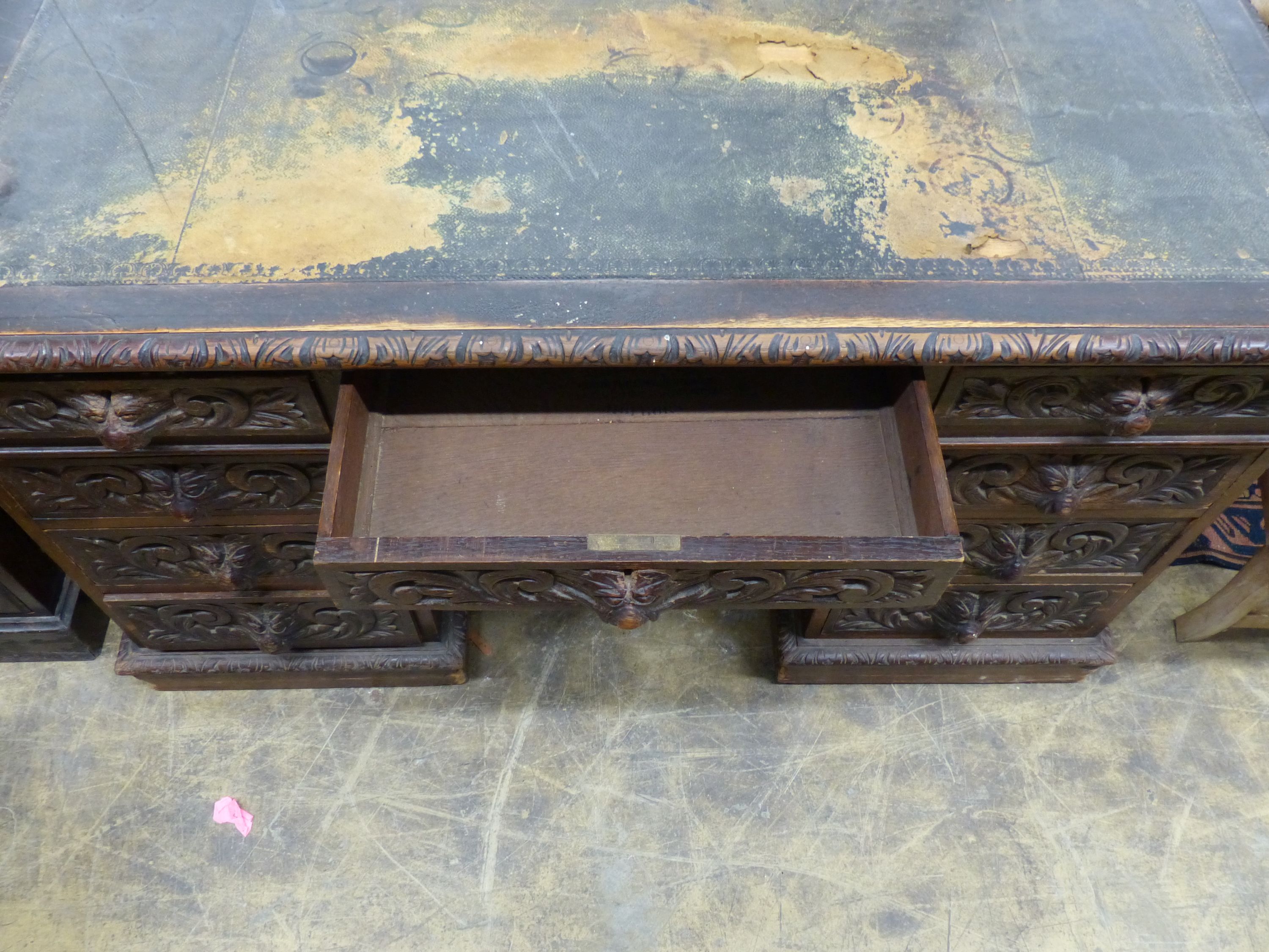 A late Victorian carved oak pedestal desk, length 138cm